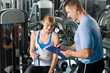 Completing personal fitness plan with trainer
