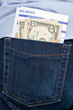 Money and payslip in back pocket.