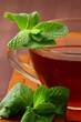 cup of tea with mint on a brown background