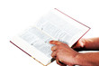 Praying hand hold an open bible