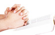 Praying hand hold an open bible