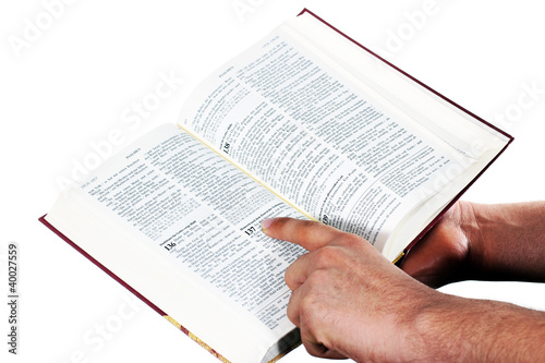 Photo: Praying hand hold an open bible Praying hand hold an open bible