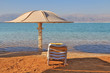 Beach umbrella and deck chair waiting for tourists Beach umbrella and deck chair waiting for tourists