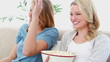 Two blonde watching TV