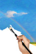 The hand with a brush draws a landscape.