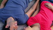Video: Happy couple lying on a blanket while holding their hands Happy couple lying on a blanket while holding their hands