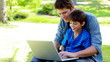 Video: Boy on his father's tigh using a laptop Boy on his father's tigh using a laptop