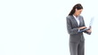 Standing businesswoman using a laptop