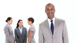 Smiling businessman standing in front of colleagues