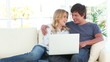 Video: Joyful couple looking at a laptop Joyful couple looking at a laptop