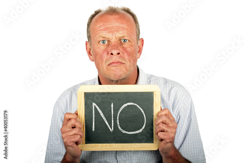 Photo: Severe looking man showing a sign with '' NO'" on it Severe looking man showing a sign with '' NO'" on it