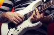 young male musician with a white guitar