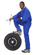 blue collar holding cross faucet resting on pneumatic tyre