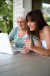 Mother and daughter using laptop