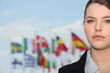 Portrait of woman in front of flags