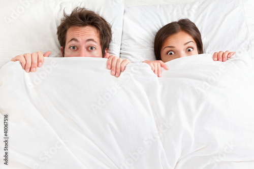 Photo: Funny surprised couple in bed Funny surprised couple in bed
