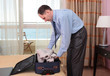 Businessman packing a suitcase