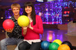 smiling young wife and husband with balls sit in bowling club smiling young wife and husband with balls sit in bowling club