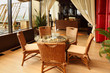 Beautiful wicker chairs and table in empty stylish restaurant