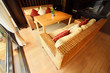 Two wicker couches with pillows and table in restaurant