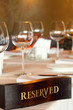 Wooden reserved plate on restaurant table with empty dishes