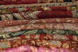 Pile Of Folded Colour Fabrics And Shawls Pile Of Folded Colour Fabrics And Shawls