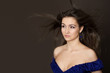 Attractive young fashion model posing in blue dress.