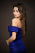 Attractive young fashion model posing in blue dress.