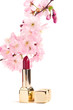 Natural cosmetics concept: new lipstick with sakura flowers