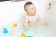 Cute baby showing tongue while taking a bath