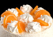 Souffle cake with marmalade fruits isolated on black closeup