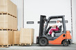 worker driver at warehouse forklift loader works