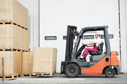 Photo: worker driver at warehouse forklift loader works worker driver at warehouse forklift loader works