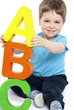 Photo: Cute boy holding giant letters - education Cute boy holding giant letters - education