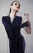 Young beautiful brunette pose in a fashionable dress