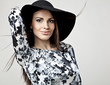 Romantic Beauty in black hat. Retro Style photo.