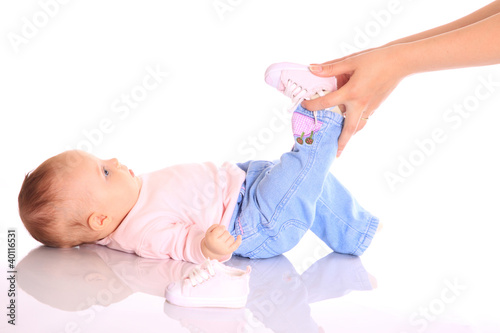 Photo: mother putting shoes on baby mother putting shoes on baby