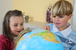 Children looking at a globe