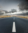 Asphalt road and the sky with dark clouds