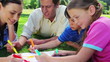Smiling family coloring together