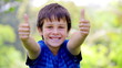 Little boy placing his thumbs up