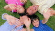 Happy family waving their hands while lying