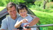 Smiling father and son fishing together