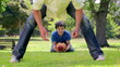 Smiling father passing the baseball to his son