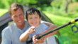Happy father and son holding a fishing rod