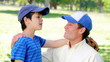 Father and son wearing baseball caps