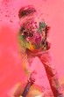 Holi celebrations in India. Boy playing with water colors.