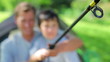 Cheerful father and son using a fishing rod