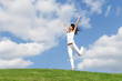 pretty young woman jumping on green grass pretty young woman jumping on green grass
