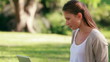 Video: Woman sitting on grass is using a laptop Woman sitting on grass is using a laptop